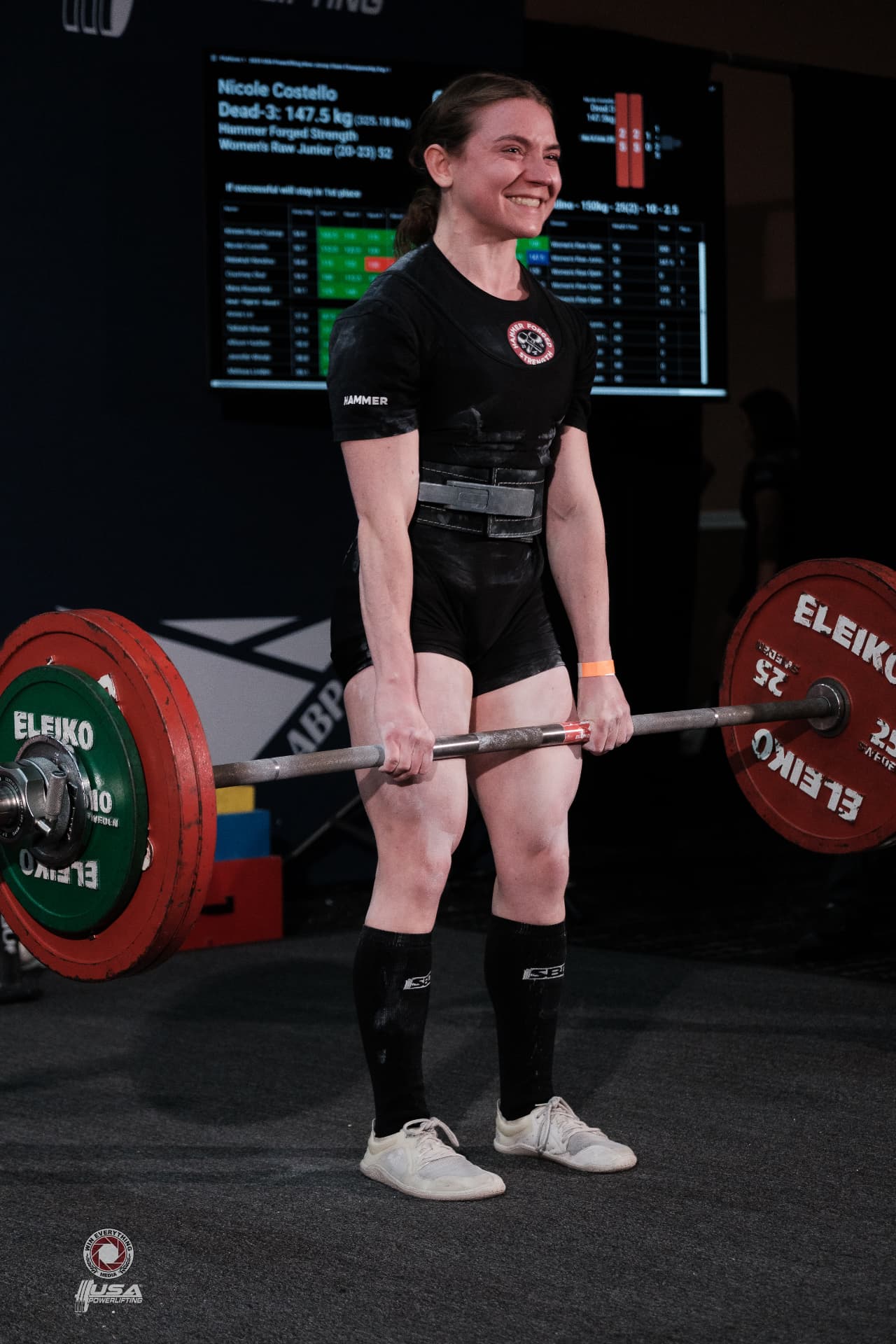 Nicole Costello smiling at deadlift lockout during a USA Powerlifting meet